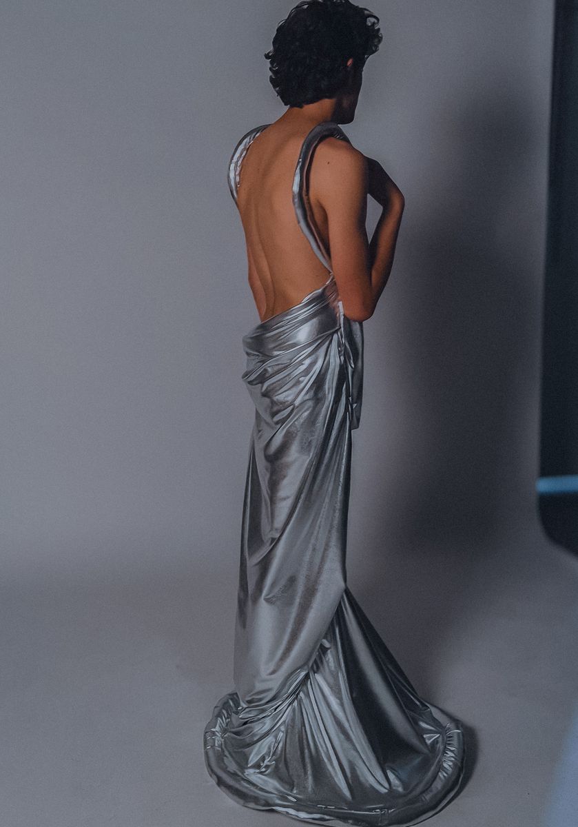 Male model in the silver open-back gown, seen from behind
